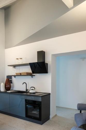 a kitchen with a sink and a stove at La balza di Scilla in Scilla