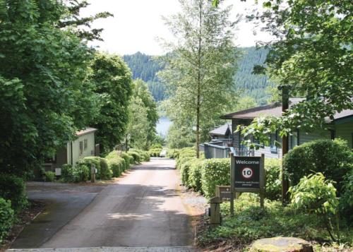 an empty street in a small town with a sign at Bassenthwaite Lakeside Lodges in Bassenthwaite