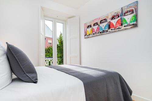 a bedroom with a bed and a painting on the wall at WHome Beato Premium River View in Quiet Area in Lisbon