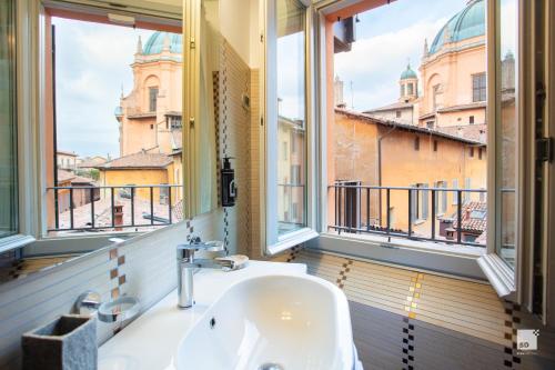 ein Bad mit einem Waschbecken und Stadtblick in der Unterkunft Urbanicooh Asinelli - Piazza Maggiore View in Bologna