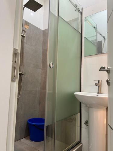 a bathroom with a shower and a sink at Chess Studio Apartments in Gwarinpa