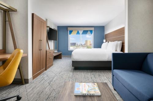 a hotel room with a bed and a couch at Holiday Inn Express Las Vegas Stadium Area by IHG in Las Vegas