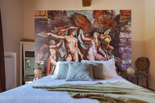 a bedroom with a mural on the wall above a bed at La Celeste Galeria in Mantova