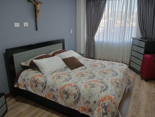 a bedroom with a bed and a dresser at descanso los ANDES in Duitama