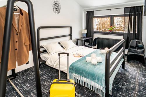 a bedroom with a bed with a yellow suitcase at Golden Lion House Bed&Breakfast in Rumia