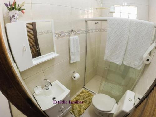a bathroom with a shower and a toilet and a sink at Casa e kitnet Morada Aguiar - casa in Abraão