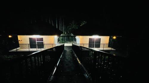 a building with two doors at night with lights at Caffeine Villa in Kaniyāmbetta