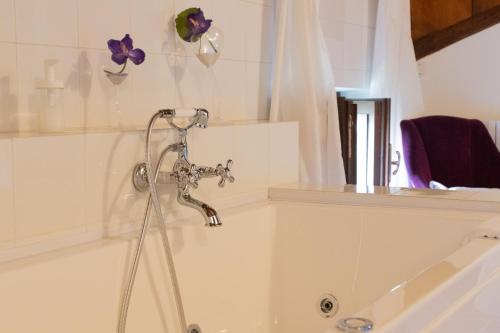 a bath tub with a faucet in a bathroom at La Celeste Galeria in Mantova