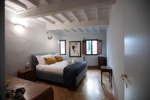 a bedroom with a king sized bed and a table at Incantevole appartamento in Oltrarno in Florence