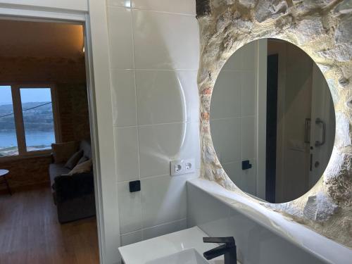a bathroom with a sink and a mirror at Apartamentos playa Buendia in Suances