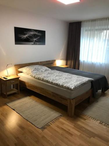 a bedroom with a large bed and a window at Wohnung Stadtmitte Würzburg, Küche, Balkon. in Würzburg