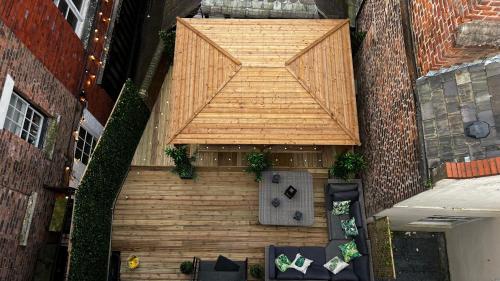 an overhead view of a patio with a large wooden wall at Romance On The Rows - Hot Tub City Centre in Chester