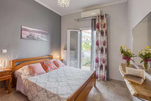 a bedroom with a bed and a window at Dimitra Apartment in Kassiopi