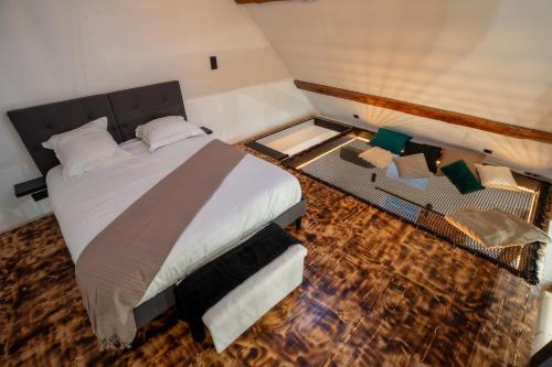 a bedroom with a large bed and a table at Le Saint-André - Clim - Loft romantique avec Jacuzzi - By Primo in Buxy