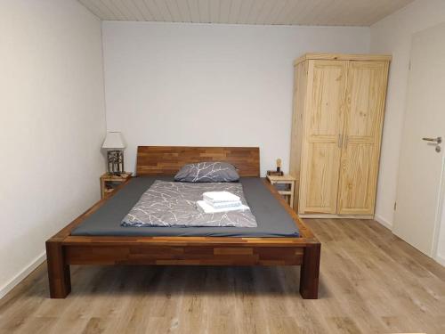 a bedroom with a bed and a wooden door at Ferienwohnung in Oberrot in Oberrot