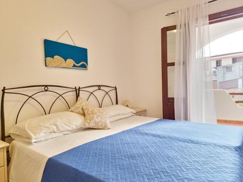 A bed or beds in a room at Le Melodie - Appartamenti con spazi esterni privati a Sos Alinos