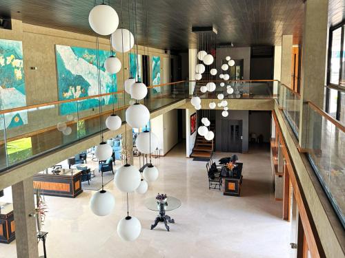 a lobby with a large chandelier in a building at DORMERO Hotel Sri Lanka Hikkaduwa Beach in Hikkaduwa