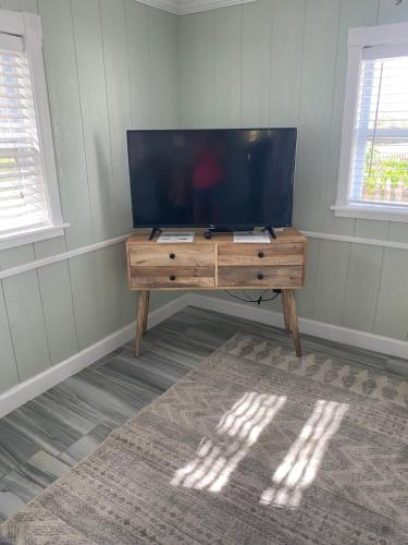 a television on a wooden table in a room at Pirates Pointe Resort in Ruskin