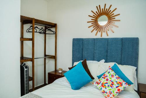 a bedroom with a bed with a mirror on the wall at Hotel Bungalows Casa Blanca in Tenancingo de Degollado
