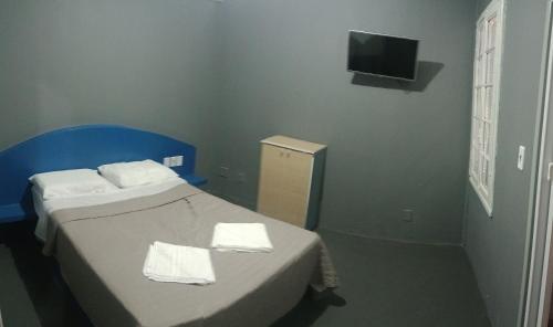 - une chambre avec un lit et 2 serviettes dans l'établissement Hotel Rest, à Porto Alegre