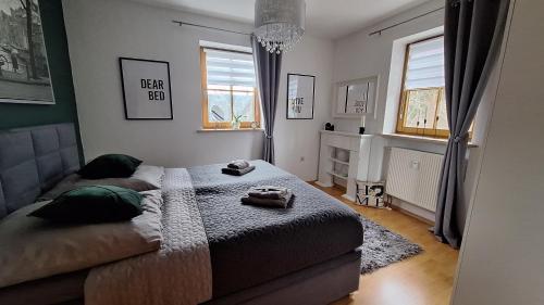 a small bedroom with a bed and two windows at Bergliebe in Germaringen