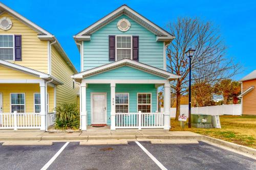 a blue and yellow house with a parking lot at Snorkel Way in Myrtle Beach