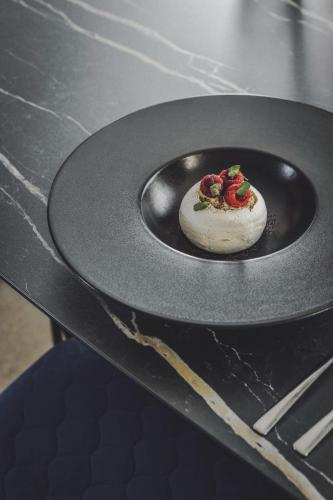 a plate with a dessert on top of a stove at 3 VIE Restaurant & Rooms in Acquarossa