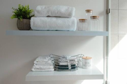 a shelf with towels and a stack of towels at Luxury 3BR Penthouse in Astria 1408 in Tegucigalpa