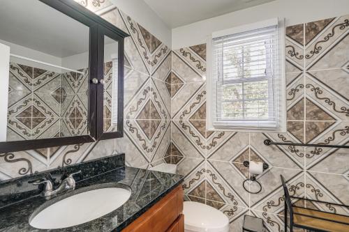 a bathroom with a sink and a mirror at Pet-Friendly Silver Spring Home 2 Mi to Downtown! in Silver Spring