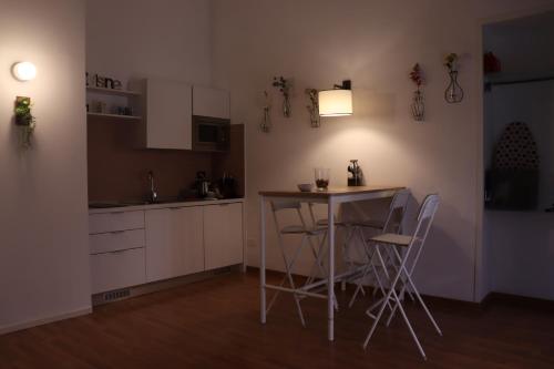 a kitchen with a table and chairs in a room at Naples Soul - city center in Naples