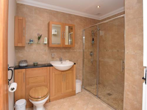 a bathroom with a shower and a sink and a toilet at 1 Bed in Colchester 58576 