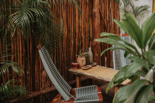 a table and two chairs in a room with bamboo at CASA CHAKÁ BOUTIQUE in Mérida
