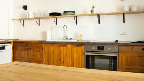 a kitchen with wooden cabinets and a sink at Le Cinquante in Groix