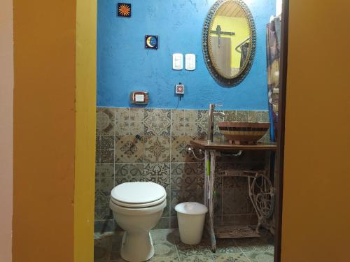 Hostel De La Tana في سان رافاييل: حمام مع مرحاض ومرآة على الحائط