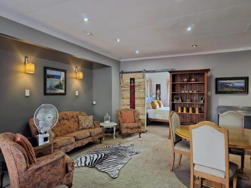 a living room with a couch and a table at Epicure Home Guesthouse in Heidelberg