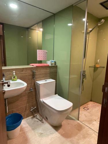 a bathroom with a toilet and a sink and a shower at Vortex Suites KLCC By Paradise IN Kuallampur City in Kuala Lumpur