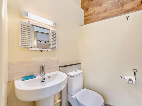 a bathroom with a white toilet and a sink at 1 Bed in Westward Ho GATAB in Bideford