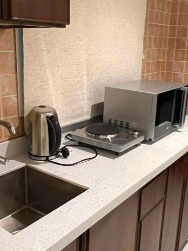 a microwave oven sitting on a counter in a kitchen at ريزا الفندقية Reeza Suites in Al Khobar