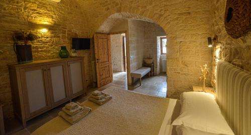 a bedroom with a bed and two towels on the floor at Masseria Morrone in Ostuni