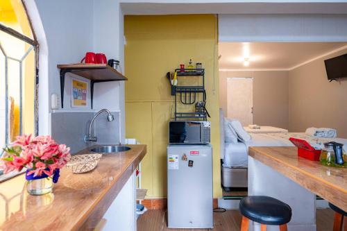 a kitchen with a sink and a refrigerator at Casa Samaykuy in Ayacucho