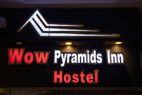 a sign for aww pyramids inn hospital at WOW Pyramids Inn With Rooftop Lounge in Cairo