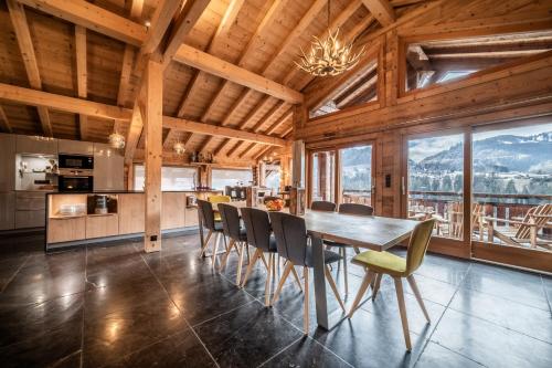 a kitchen and dining room with a table and chairs at Chalet Heavenly Morzine - by EMERALD STAY in Montriond