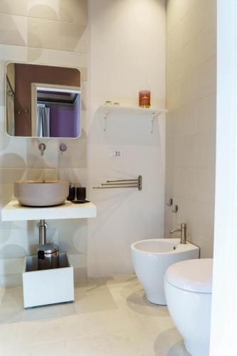a bathroom with a sink and a toilet at Le Volte And Suite in Catania
