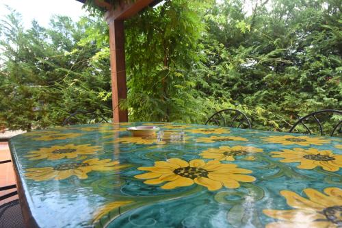 a table with a table cloth with yellow flowers on it at Casa Vacanze Il Cenito in Castellabate