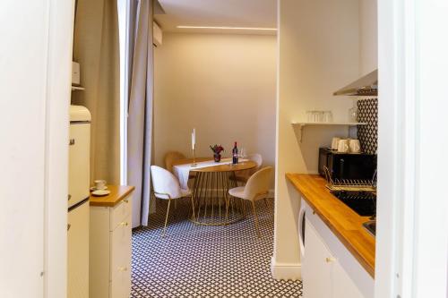 a small kitchen with a table and a dining room at Le Volte And Suite in Catania