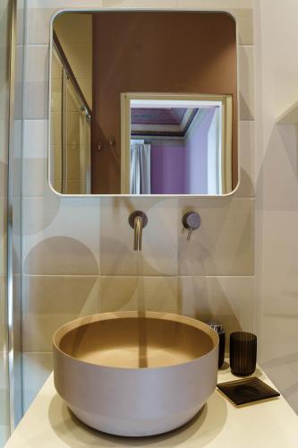 a sink in a bathroom with a mirror at Le Volte And Suite in Catania