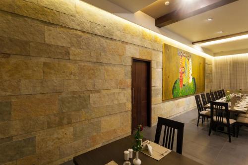 a dining room with a stone wall at Hotel Chaitali - Pure Veg in Kolhapur