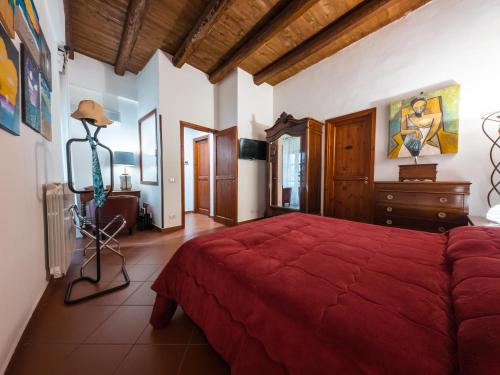 a bedroom with a red bed and a dresser at Casa Ruggiero in Palermo