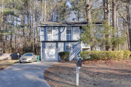 a blue house with a car parked in front of it at Lithonia Home, 5 Mi to Panola Mountain State Park in Lithonia