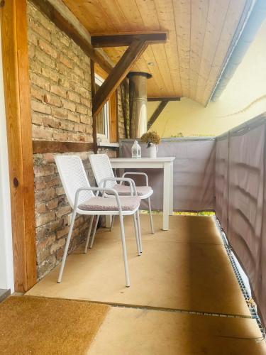 a patio with two chairs and a table at Monteurwohnung Ferienwohnung in Groß-Gerau